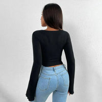 Woman’s black long-sleeved top and blue jeans.