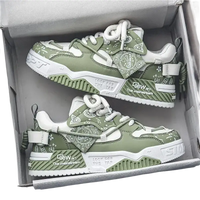 Green and white sneakers in a box.