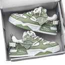 Green and white sneakers in a box.