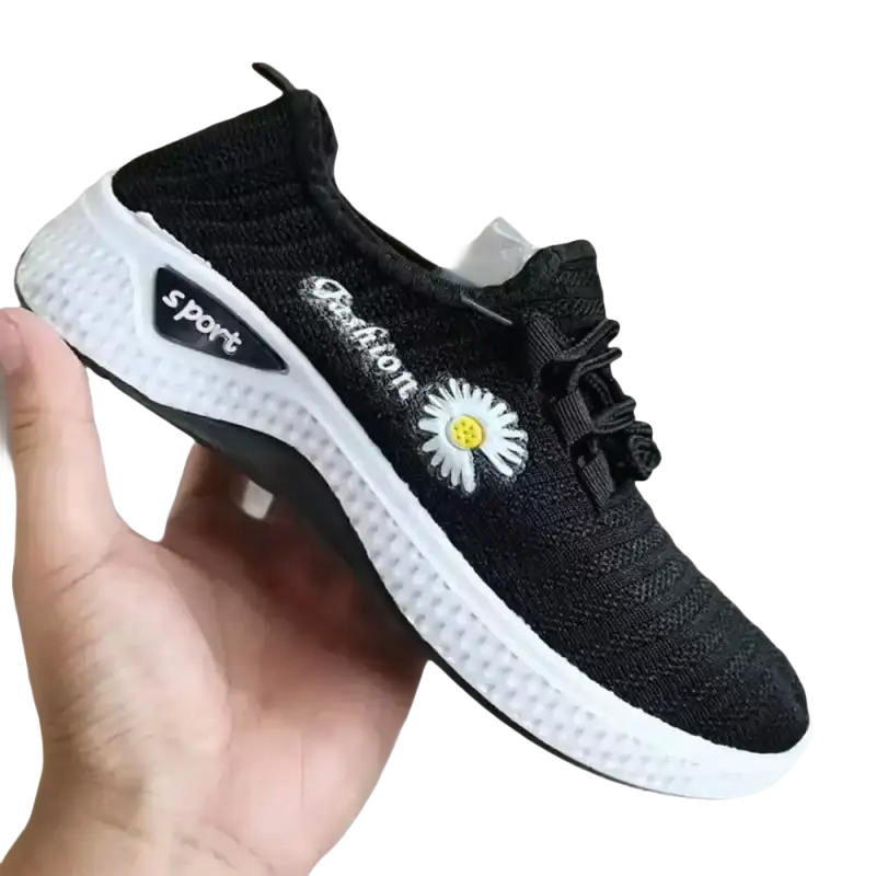 Black knit women’s sports shoes with white mesh soles and daisy detail