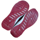 Red athletic shoe soles on trendy fashionable women’s sports shoes for sporty style