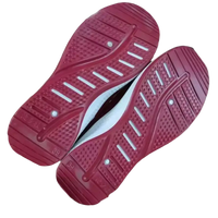 Red athletic shoe soles on trendy fashionable women’s sports shoes for sporty style