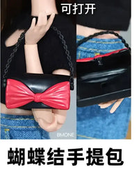 Black purse with red bow.