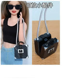 Miniature black purse with silver chain.