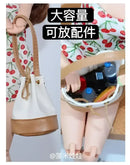 Miniature bucket bag with accessories.
