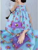 Doll wearing a floral dress and holding a purple purse.