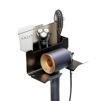 Wall-mounted bathroom organizer with hair dryer holder.