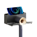 Wall-mounted hair dryer holder with phone slot.