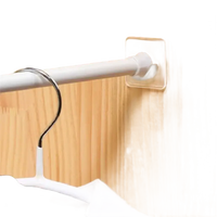 Adhesive-mounted closet rod.