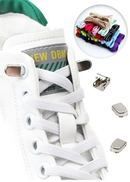 White sneaker with shoelaces and metal accessories.