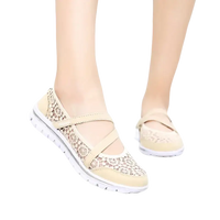 Beige lace-patterned walking shoes.