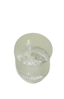 Ribbed glass being filled with water.