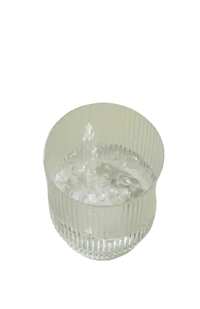 Ribbed glass being filled with water.