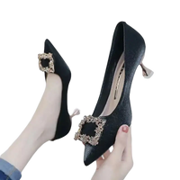 Black high-heeled pumps with jeweled buckle.