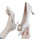 Elegant white high heels with jeweled buckle.