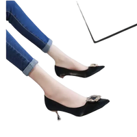 Black high heels with jeweled buckles.