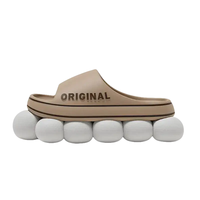 Beige slide sandal on white spheres.
