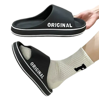 Black slide sandals with white trim.
