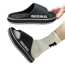 Black slide sandals with white trim.