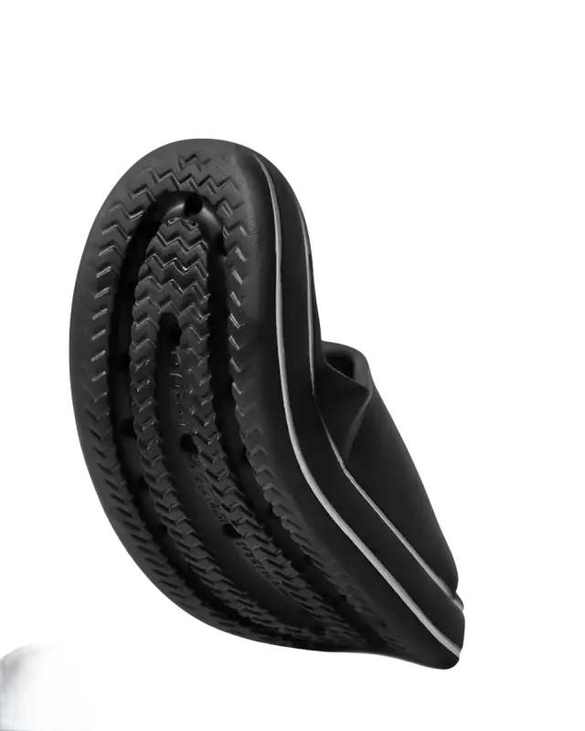 Black slipper with textured sole.