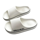 White slide sandals with black trim.