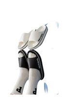 White and black ’Original’ slide sandals.