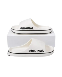 White slide sandals with black trim.