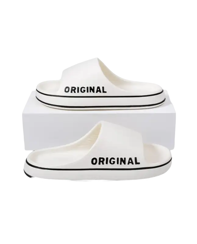 White slide sandals with black trim.