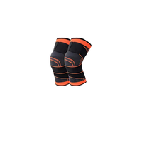 Pair of black and orange knee braces.