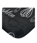 Black kitchen mat with white utensil designs.