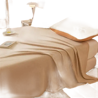 Beige blanket on a bed.