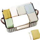 Fabric storage basket with folded clothes.