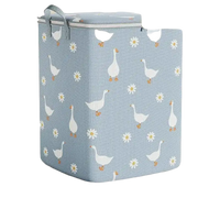 Blue laundry hamper with goose and daisy pattern.