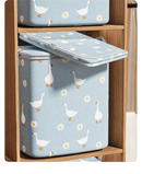 Blue storage containers with goose and daisy pattern.