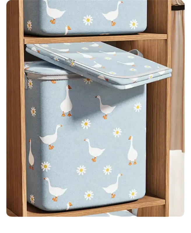 Blue storage containers with goose and daisy pattern.