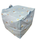 Blue storage cube with swan and daisy pattern.