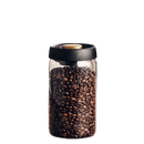 Coffee bean-filled glass jar with black lid.