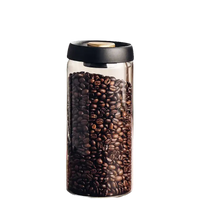 Coffee bean-filled glass jar with black lid.