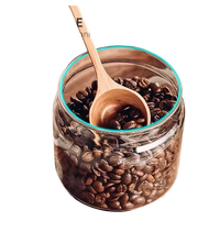 Coffee bean storage jar with wooden scoop.