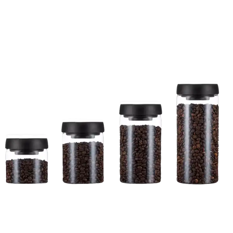 Four glass storage jars with black lids.