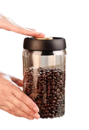 Glass jar filled with coffee beans.