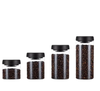 Glass storage jars with black lids.