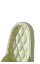 Tufted, light-colored chair back.