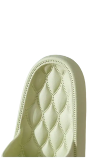 Tufted, light-colored chair back.