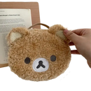 Round, fuzzy, brown bear purse.
