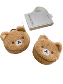 Two fuzzy brown bear-shaped purses.