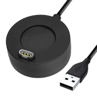 Black circular smartwatch charger with USB cable.