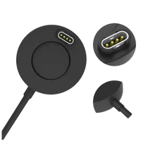 Black circular charging puck with gold-plated pins.