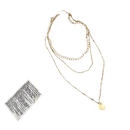 Gold layered necklace with a circular pendant.