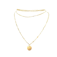 Gold-toned layered necklace with pendant.